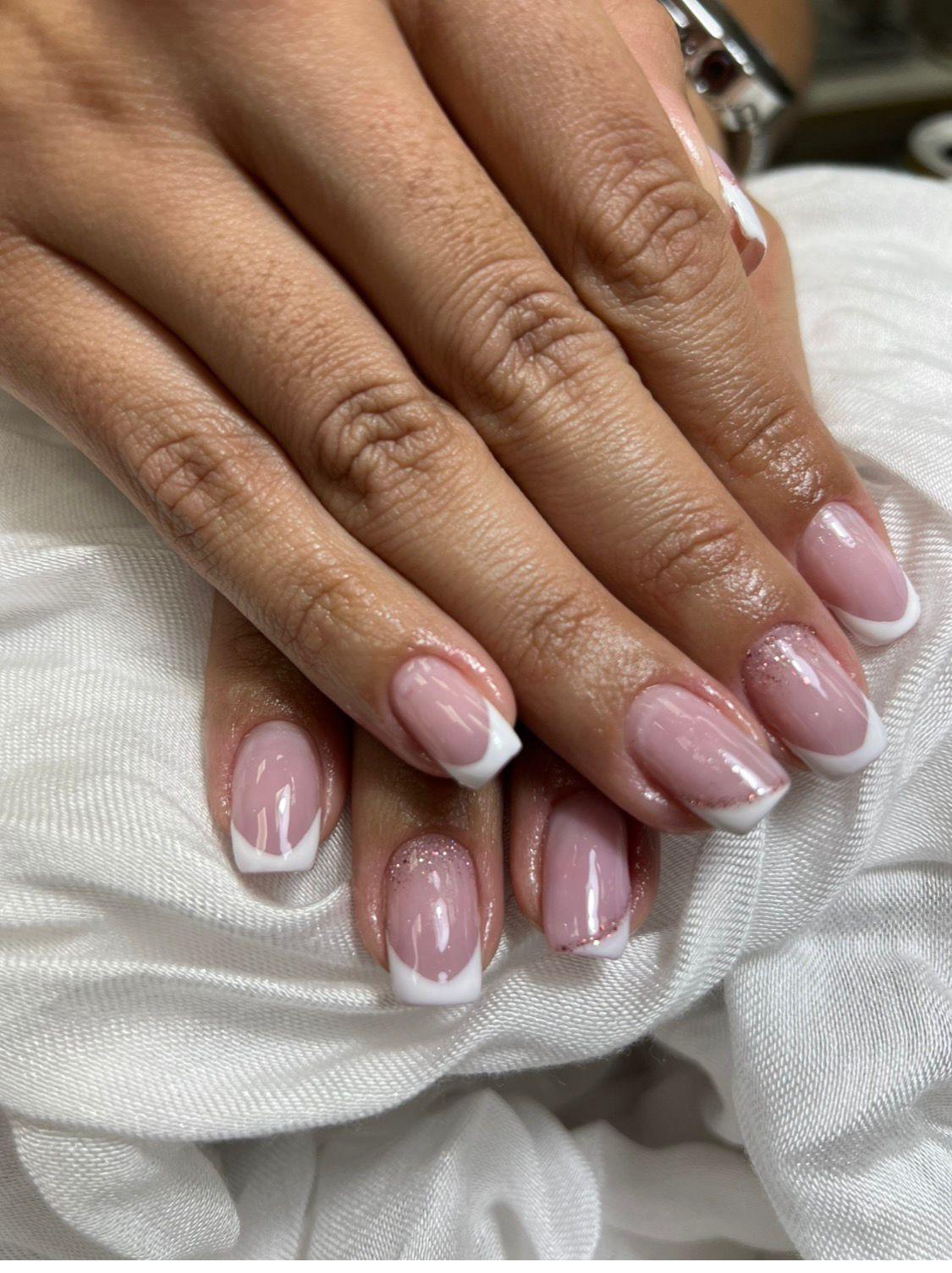 Classic French tips with soft glitter accent